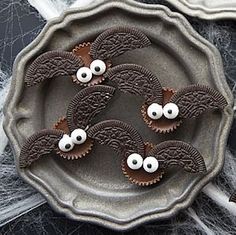 chocolate bats decorated with googly eyes on a plate