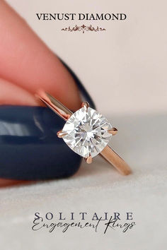 a woman's hand holding a diamond ring with the words solit alvre engagement rings