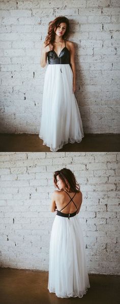 a woman in a white dress standing next to a brick wall