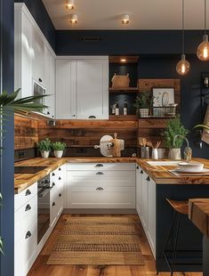 a kitchen with white cabinets and wooden counter tops, along with potted plants on the wall