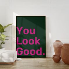 a poster with the words you look good in pink on it next to vases