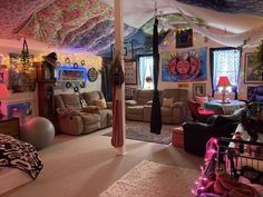 a living room filled with lots of furniture and decor on top of carpeted flooring