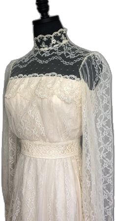 a white dress with sheer sleeves and lace