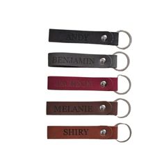 four leather key chains with names on them