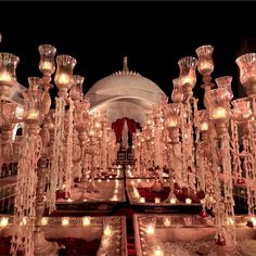 an elaborately decorated room with candles and chandeliers