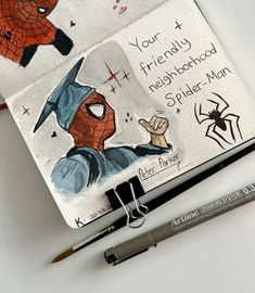 two notebooks with spider - man drawings on them next to a pen and marker