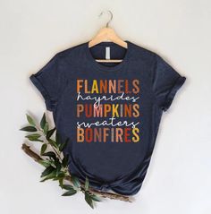 Flannels Pumpkins Bonfires T-Shirt, Fall Season Shirt, Autumn Outfit, Pumpkin Lover Gift Shirt, Thanksgiving Family Shirt, Thankful Gift HOW TO ORDER 1-) Please, check and review all the photos. 2-) Choose your t-shirt size and color. *Different styles of shirts may have different shades of the same color choice due to different manufacturer brands. *For this reason, we recommend matching shirts from the same styles if you want precisely matching colors (ex. Unisex, V-necks, Toddler, etc.). 3-) Fall Crew Neck T-shirt With Name Print, Casual Fall T-shirt With Name Print, Casual Name Print T-shirt For Fall, Shirt Autumn Outfit, Thanksgiving Shirts For Women, Thankful Pumpkin, Cute Fall Shirt, Thanks For The Gift, Thanksgiving Family