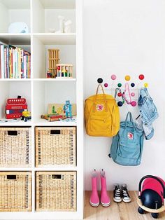 a child's room with toys, bookshelves and baskets on the floor