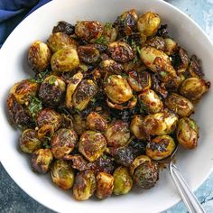 a white bowl filled with cooked brussel sprouts