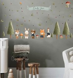 a baby's room with woodland animals on the wall