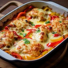 a casserole dish with tomatoes and meat on it, next to a spatula