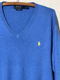 Vintage polo Ralph Lauren blue V-neck sweater. Size large. Made in China. 100% Pima cotton. Blue Casual Polo Sweater With Polo Collar, Blue Casual Polo Sweater, Classic Cotton V-neck Polo Sweater, Blue Cotton V-neck Sweater For Winter, Casual Blue Cotton V-neck Sweater, Blue Classic Sweater With Ribbed Collar, Classic Blue Sweater With Ribbed Collar, Blue Polo Collar Sweater For Fall, Blue Polo Sweater For Fall