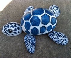 a blue and white turtle statue sitting on top of a cement ground with the words garden decoration above it