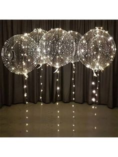 some balloons with lights hanging from them