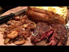 a plate with steak, potatoes and bread on it