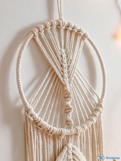 a white macrame hanging on the wall