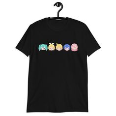 a black t - shirt with three cartoon characters on the front and one is wearing an ear