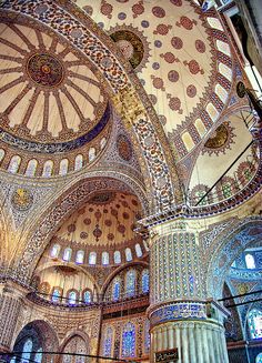 the inside of a large building with many windows and arches on it's ceiling