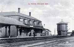 an old black and white photo of a train station