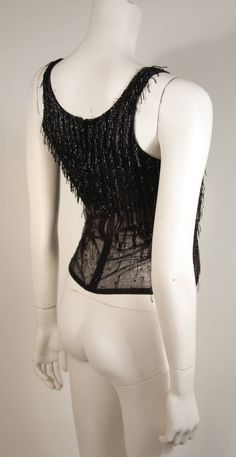 Versace Atelier Beaded Black Mesh Evening Top Size Small | From a collection of rare vintage shirts at https://www.1stdibs.com/fashion/clothing/shirts/ Stretch Beaded Top For Party, Elegant Sleeveless Mesh Top For Evening, Embellished Stretch Mesh Top For Evening, Embellished Stretch Mesh Party Top, Embellished Stretch Mesh Top For Party, Black Sleeveless Mesh Top For Evening, Elegant Fitted Sequin Mesh Top, Fitted Embellished Mesh Top For Evening, Glamorous Party Tops With Beaded Fringe