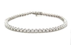 This beautiful Diamond Riviera Line Tennis Bracelet offers sparkling sophistication for any occasion with 1.95ct t.w. of dazzling diamonds, it will make you shine with undeniable elegance. Make your statement of style today! Metal: 14K White GoldDiamond Weight: Rounds Brilliant cuts 1.95ct t.w.Bracelet Length: 18cmLock: Box Catch With Hidden Safety Estimated production time is 4 - 5 weeks. Elegant Diamond Tennis Bracelet With Pave Setting, Timeless Wedding Tennis Bracelet With Pave Setting, Timeless Tennis Bracelet With Pave Setting For Wedding, Dazzling White Gold Tennis Bracelet With Pave Setting, Dazzling Diamond Bracelet With Pave Setting For Formal Occasions, Formal Tennis Bracelet With Pave Setting, Dazzling Diamond Tennis Bracelet With Pave Setting, Diamond White Tennis Bracelet With Pave Setting For Anniversary, Classic White Gold Diamond Bracelet With Pave Setting