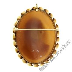 "This unique vintage brooch or pendant was crafted from solid 14k yellow gold. It features a large oval shaped carved shell cameo bezel set at its center. The piece of shell used for this particular carving is very uniquely convex shaped allowing the portrait to have a domed 3D look. That cameo is then surrounded by a pair of twisted wire frames with a finer one on the inside and a much coarser one on the outside.This unique vintage piece remains in excellent and 100% ready to wear upon arrival. Gold Oval Carved Brooches, Oval Carved Gold Brooches, Antique Oval Cabochon Brooches, Oval Cabochon Brooches For Anniversary, Antique Oval Carved Brooches, Yellow Gold Oval Cameo Brooch, Classic Oval Brooches For Collectors, 3d Portrait, Carved Shell