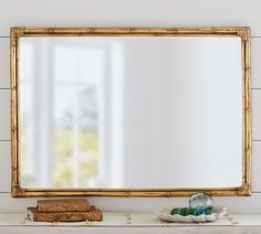 a mirror sitting on top of a white mantle