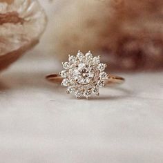 a diamond ring sitting on top of a table