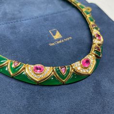 Excellent Condition Vintage Van Cleef & Arpels choker necklace.A true heirloom which will be wearable the moment it arrives. Excellent Condition, no damage to any of the gemstones. All joints are tight and secure. This vintage, handcrafted Van Cleef Arpels necklace is the epitome of sophisticated elegance. Crafted in 18K yellow gold, it features a stunning inlay of chrysoprase throughout, with pink tourmaline stones as the centerpiece, and is accented with brilliant diamonds, offering a timeless look that is sure to add a touch of luxury to any ensemble. Details: 18K Yellow Gold Weighs 145.97 grams 16" Long Hallmarked Van Cleef Arpels 18K B4589I1 Integrated hinged clasp Includes original Van Cleef Arpels Blue Pouch Green Chrysoprase Chalcedony Inlays Center Pink Tourmaline = Approximately Luxury Green Cabochon Necklace, Van Cleef Arpels Blue, Van Cleef Arpels Green, Van Cleef Arpels Necklace, Vintage Van Cleef, Yellow Gold Cuff Bracelet, Van Cleef & Arpels, Gold Cuff Bracelet, Vintage Tiffany