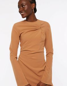 An elevated piece that speaks to evening dressing, the ESCAPADE dress features a twist at the front and ruched details taht gather the fabric creating a flattering look. With the side slits it is a chic answer to occasionwear.The model is 178 cm and wears a size S.Composition: 51% RPES, 39% PES, 10% ELMachine wash delicate 30 celsius, do not bleach, iron on a low temperature without steaming, do not tumble dry, do not dry clean. Shine may appear while ironing.Size and fit:To make sure you choose the right piece, please follow the size chart below! XS S M L XL Chest 84 cm 88 cm 92 cm 96 cm 102 cm Waist 66 cm 70 cm 74 cm 78 cm 84 cm Hip 94 cm 98 cm 102 cm 106 cm 112 cm Arm length 69 cm 59,5 cm 71 cm 71,5 cm 73 cm Arm width 30,5 cm 31,5 cm 32,5 cm 33,5 cm 35 cm Front length 129 cm 130 cm 132, Brown Draped Evening Dress, Elegant Brown Asymmetrical Midi Dress, Chic Long Sleeve Midi Dress With Ruched Sides, Elegant Brown Draped Dresses, Elegant Draped Brown Dress, Fall Ruched Midi Dress For Dinner, Chic Mini Dress With Ruched Bodice For Fall, Chic Midi Dress With Ruched Bodice For Fall, Formal Ruched Sheath Mini Dress