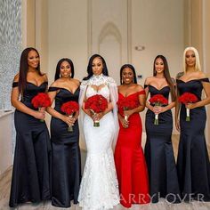 a group of women standing next to each other in formal wear and holding bouquets