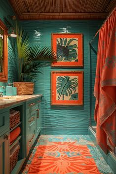 an orange and blue bathroom with two paintings on the wall