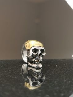 Silver skull ring with 24k solid pure gold bandanna and tooth. Hand carved skull and fabricated bandanna and tooth. 100% made from recycled materials. Carved Skull, Silver Skull Ring, Skull Carving, Recycled Silver, Skull Ring, Pure Gold, Rings Statement, Recycled Materials, Statement Rings