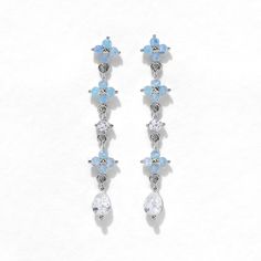 Take beauty wherever you go in the Blue Blossom Love Dangle Earrings. This design has become a GC favorite and is here to stay! You'll get lost in the stunning and calming baby blue hues of the cubic zirconia stones. Pale Blue Earrings, Light Blue Crystal Drop Earrings For Gift, Blue Cubic Zirconia Drop Earrings, Blue Cubic Zirconia Crystal Earrings For Pierced Ears, Elegant Light Blue Hypoallergenic Earrings, Lilac Outfits, Dusty Pink Weddings, Blue Blossom, Prom Earrings