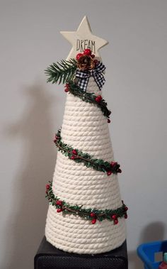 a christmas tree made out of rope with a star on top