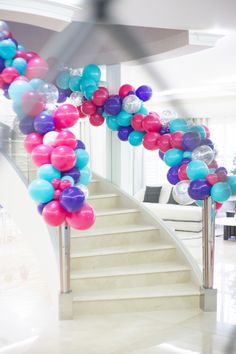 a staircase decorated with balloons and streamers