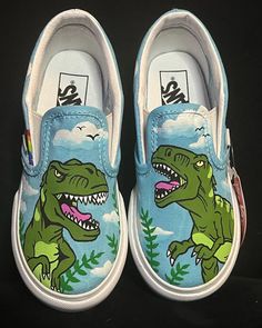 Dinosaur/t-rex themed hand painted kids vans **Please be sure of your size when ordering. No returns, exchanges or refunds as each pair is custom handmade.** **No way affiliated or endorsed with the companies, subsidiaries or affiliates of any of the content I paint on the shoes** Q. What is your turn around time? A. Usually I have many orders at one time so I do ask for UP TO 3 WEEKS to have the time to order the shoes, work on them in order received and drop them off with USPS. Q. Do you do re Shoe Painting Ideas Vans, Shoe Painting Ideas, Hand Painted Vans, Dinosaur Shoes, Painted Shoes Diy, Custom Sneakers Diy, Shoe Painting, Painted Canvas Shoes, Painted Vans