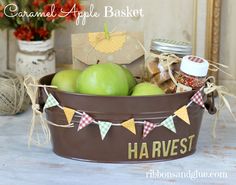 a basket filled with green apples sitting on top of a table next to other items