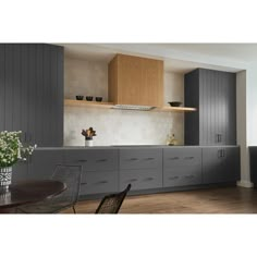 a kitchen with gray cabinets and wooden floors