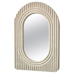 an oval shaped mirror is shown against a white background with wavy lines on the edges