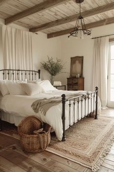 a bedroom with a bed, rug and basket on the floor in front of it