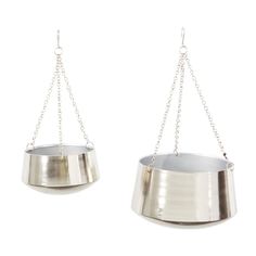 two metal hanging pots with chains attached to them