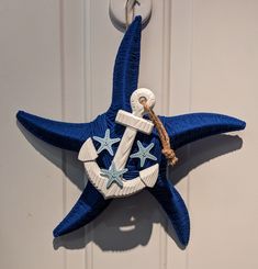 a blue and white starfish ornament hanging on a door