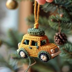 a crocheted car ornament hanging from a christmas tree