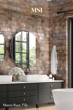 a bathroom with two sinks, mirrors and a bathtub in front of a brick wall