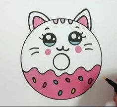 a drawing of a pink donut with sprinkles and a cat's face