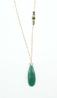 A large Emerald green Adventurine Crystal is adorned with a Swarovski Rhinestone rondelle and cap. 34”in length this amazing necklace is everyday wear or perfect for a dressy occasion. Dangles with easy movement from 14k gold fill or sterling silver. Extremely high quality chain and clasp with all closed jump rings. Side detail makes the necklace absolutely amazing, green Swarovski crystals. Available in Sterling silver or 14K gold fill chain.Custom Length available, just ask!Match with the Lind Green Teardrop Faceted Necklace, Elegant Green Faceted Crystal Necklaces, Green Faceted Briolette Necklaces, Green Faceted Briolette Necklace, Green May Birthstone Long Drop Jewelry, Green Briolette Faceted Necklace, Green Teardrop Necklace With Faceted Beads, Green Single Strand Long Necklace, Green Long Single Strand Necklace