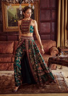 Editor's Note Featuring a classically feminine silhouette, hand painted and printed with floral motifs in vibrant colours. It is intricately adorned with embroidery and coin-work. The skirt is a combination of palazzo pants and wrap around skirt. Fabric: Blouse & lehenga: viscose silk Color: Green Components: Blouse and lehenga Occasion: Wedding Guest and festive Disclaimer: Product color may slightly vary due to photographic lighting sources or your monitor setting. Care: Dry Clean Only About t Indian Skirt Designs, Western Lehenga Designs Latest, Palazzo Lehenga, Indowestern Outfits, Delhi Fashion, Skirt Indian, Lehenga And Blouse, Rahul Mishra, Saree Blouse Styles