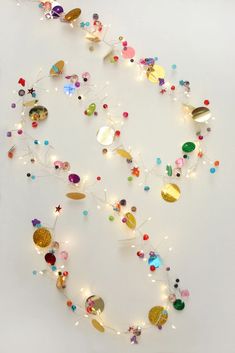 a white wall covered in lots of different colored beads