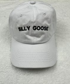 The words silly goose embroidered on a unstructured dad baseball hat.  Customize you hat with your choice of color. Primary Color is the hat color.  Item Details: 100% cotton twill Pigment dyed Garment washed Low Profile 6 panel Brass buckle or Velcro adjustable strap One size fits most No returns or exchanges on customized items. Please contact me at any time for concerns about your purchase. Cheap Fun Hats With Curved Bill, Cheap Novelty Hats With Curved Bill, Cheap Fun Hat With Curved Bill, Cheap Funny Hats With Curved Brim, Cheap Fun Snapback Hat For Baseball Season, Cheap Funny Adjustable Hats, White Dad Hat With Letter Print And Flat Bill, Casual Trucker Hat With Letter Embroidery And Curved Brim, Casual Snapback Hat With Curved Brim And Letter Embroidery